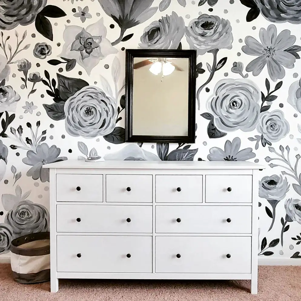 black and white nursery room with floral wallpaper